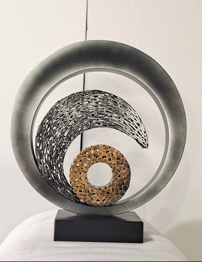 Decorative hanging sculpture with circular design on a white background