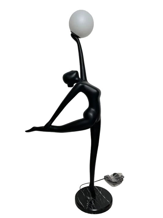 Black abstract sculpture with a spherical object on a white background