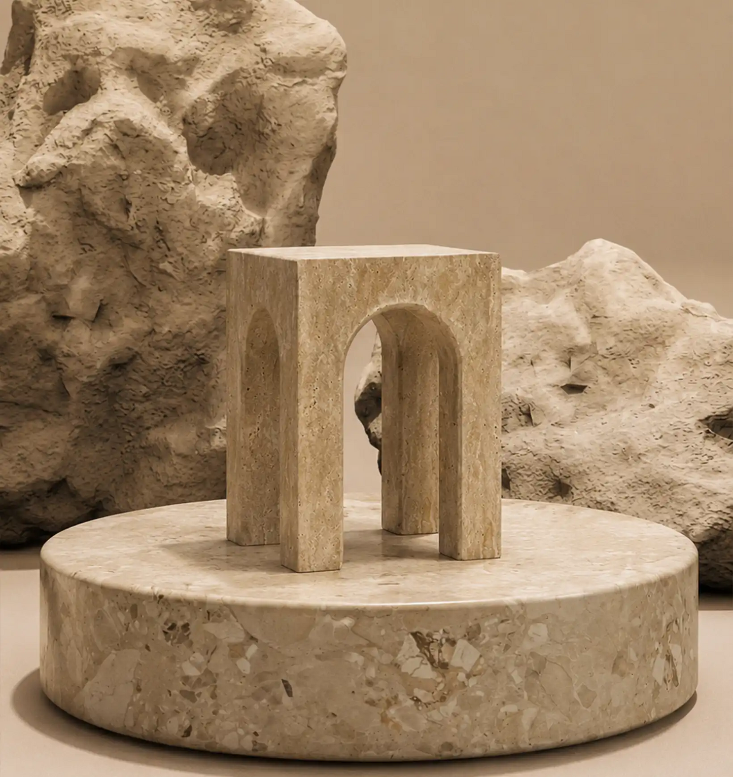 A beige marble display stand with a square top and two arched openings, on a round marble base
