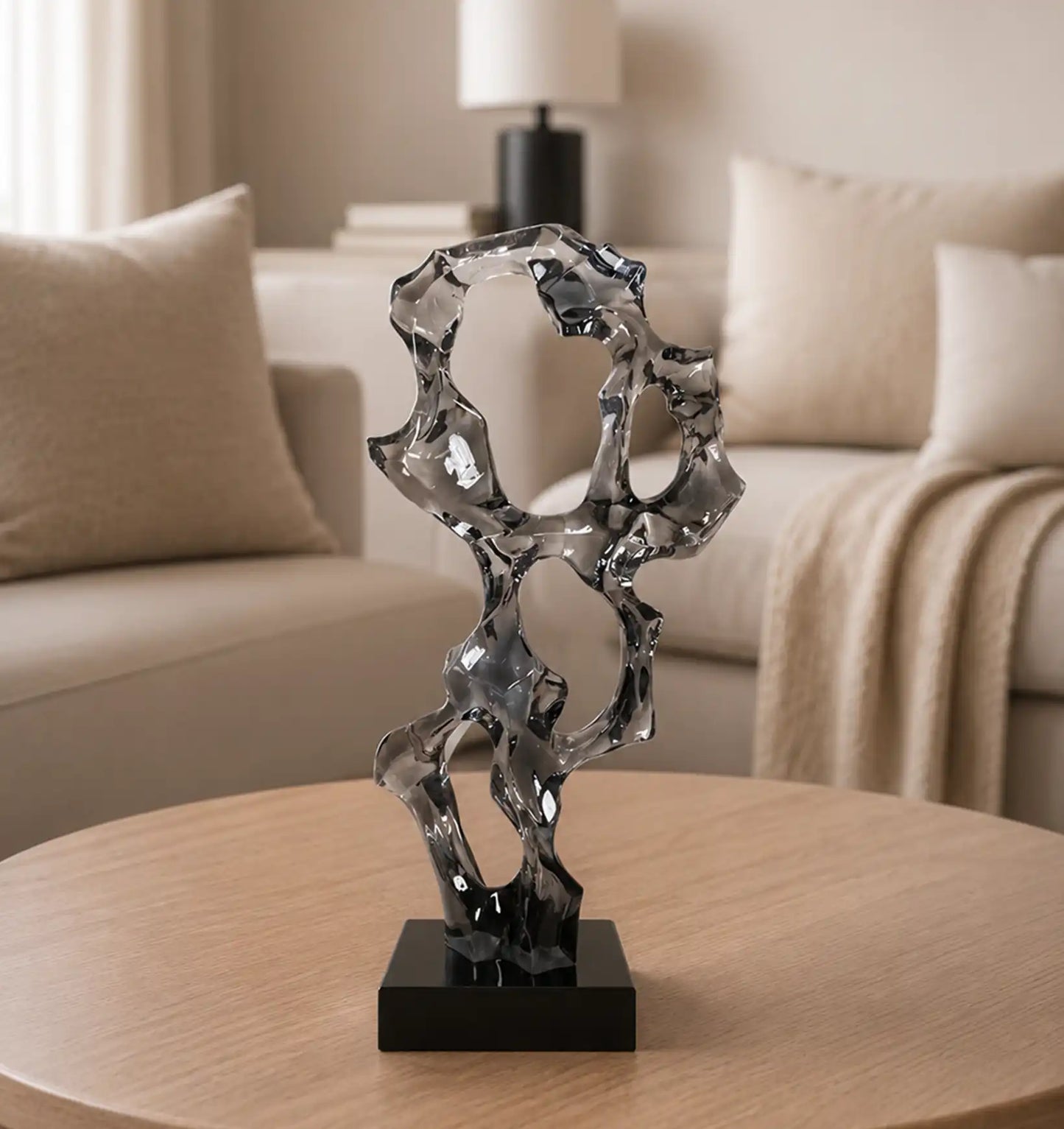 Abstract glass sculpture on a wooden table in a living room
