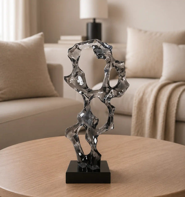 Abstract glass sculpture on a wooden table in a living room
