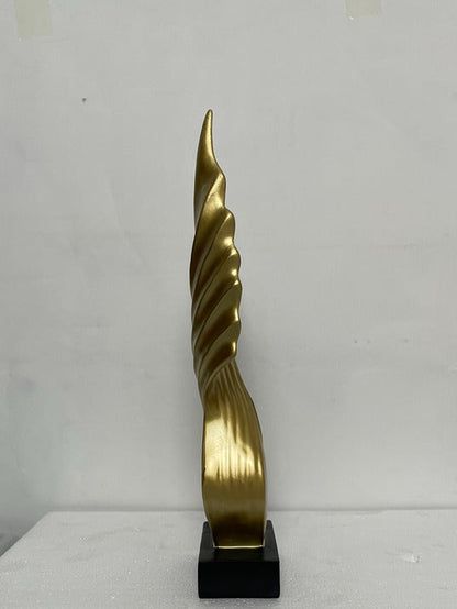 Gold spiral sculpture on a black base against a white background