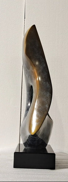 Abstract sculpture on a white pedestal against a plain background