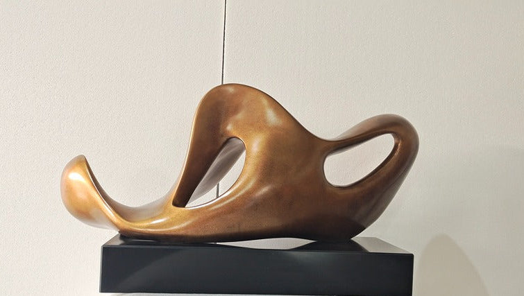 Bronze sculpture on a black base against a neutral background