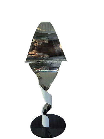 Decorative mirror with a black base on a white chair