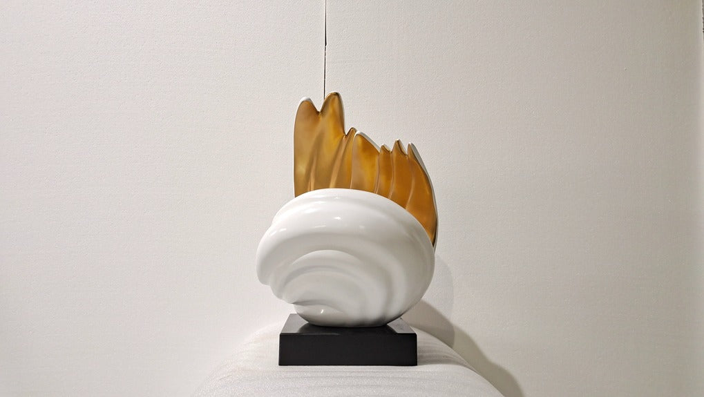 Modern pendant light with white base and brown glass shade on a plain background