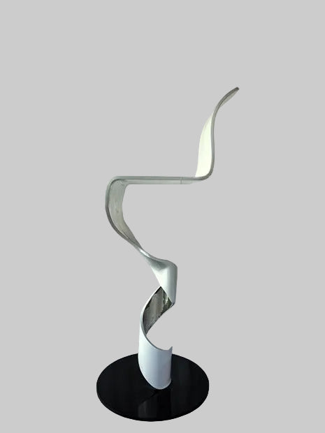 Modern floor lamp with a black base and white spiral design on a textured surface.