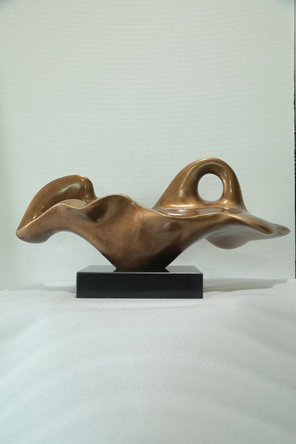 Bronze abstract sculpture on a white background