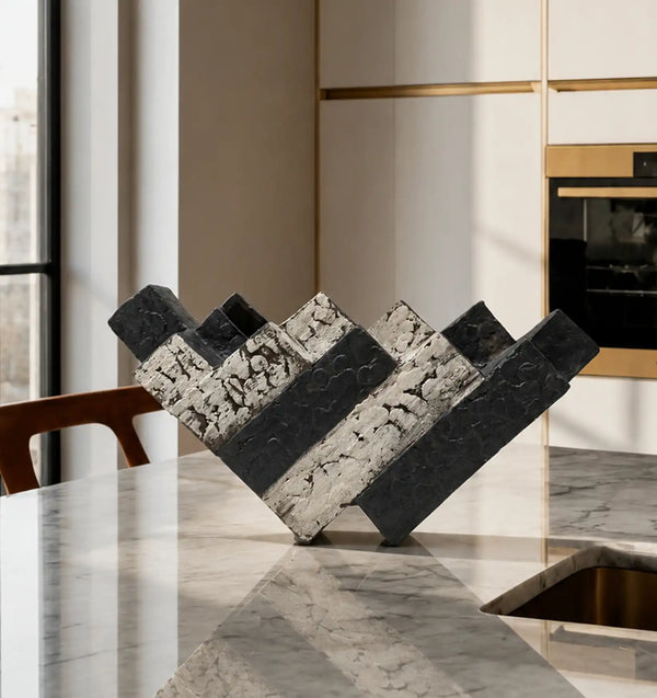 Black and white textured decorative object on a marble kitchen island